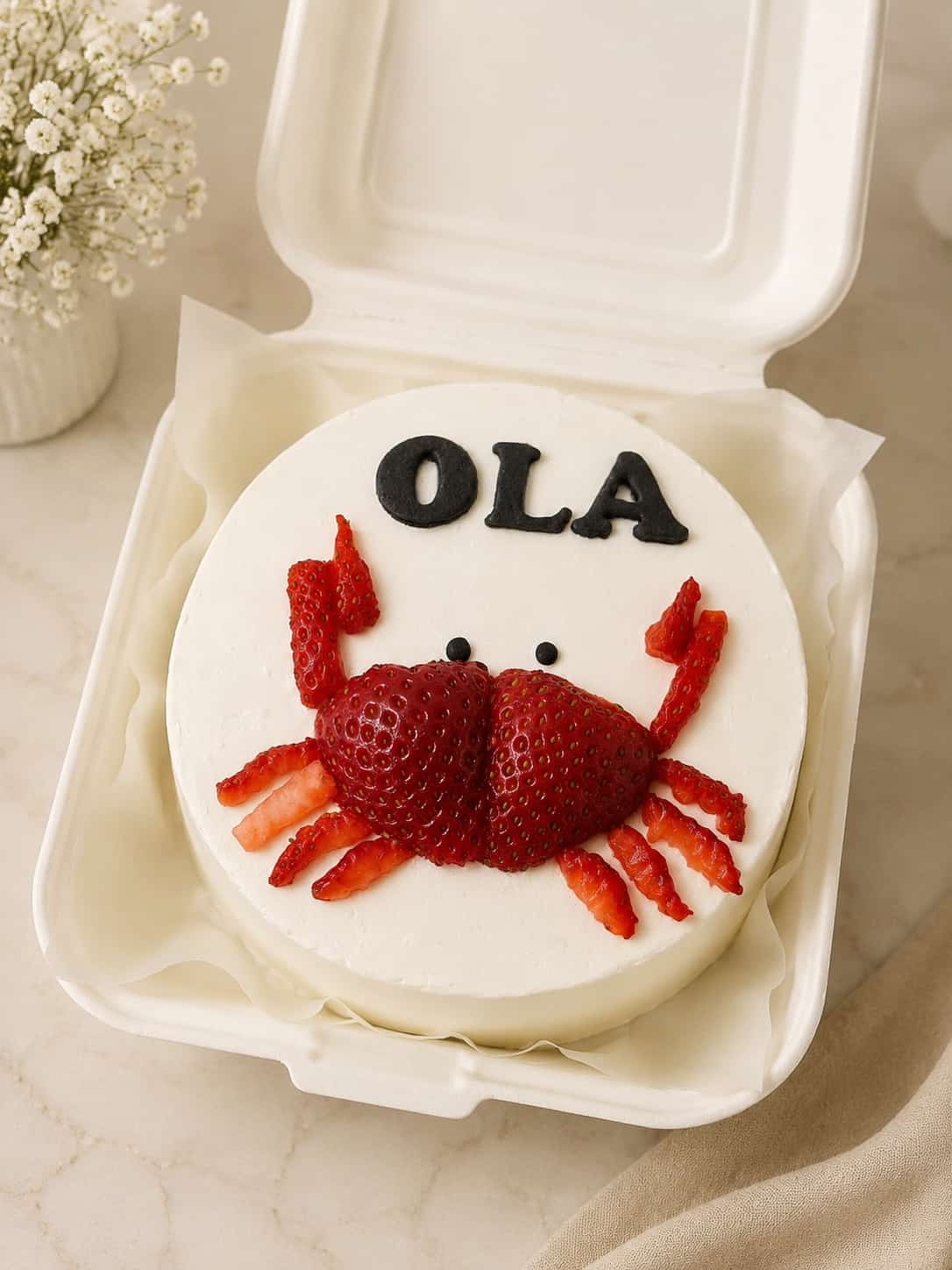 Mini white bento cake decorated with a cute crab made of fresh strawberries, a fun fruit themed bento cake in Bahrain.