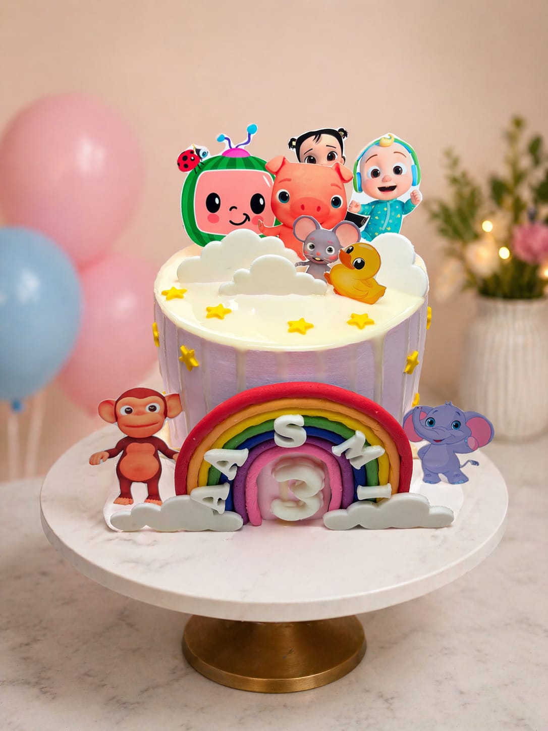 Purple drip Cocomelon theme 3rd birthday cake with character cutouts, a fondant rainbow and jungle animals, by CakeCanva in Bahrain.